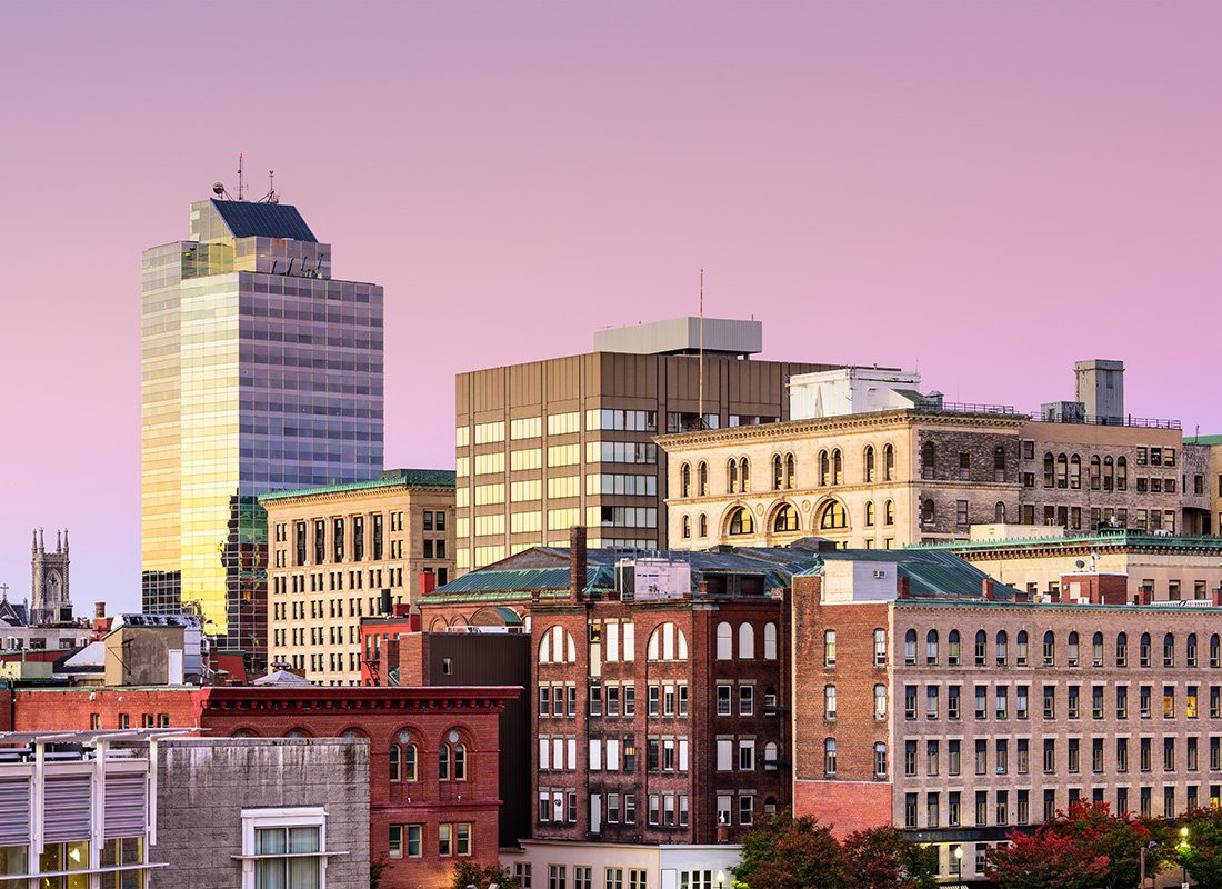Worcester, MA - View of Traditional and Modern Commercial Buildings and Apartments in Downtown Worcester Massachusetts Against a Colorful Sunset Sky